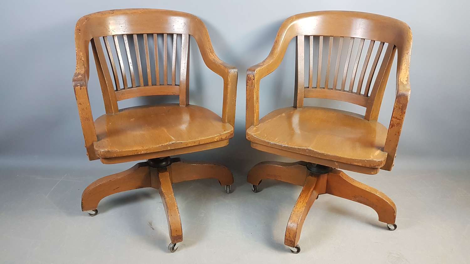 Pair of vintage walnut desk chairs in old paint