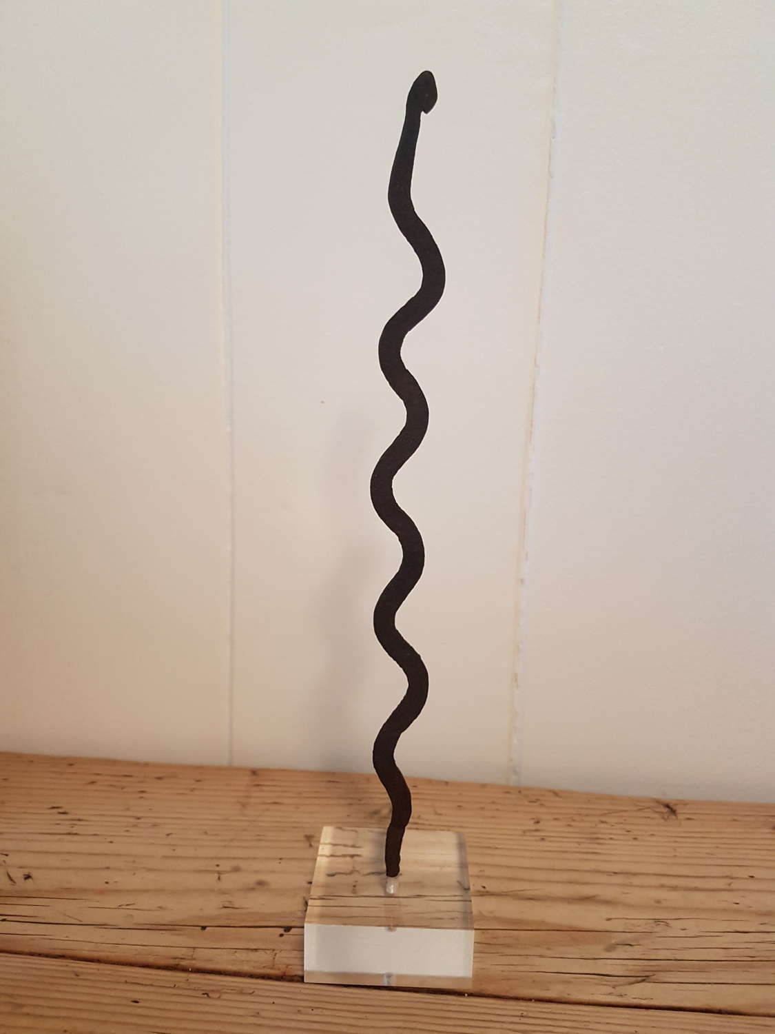 Lobi Iron Snake Currency on lucite stand