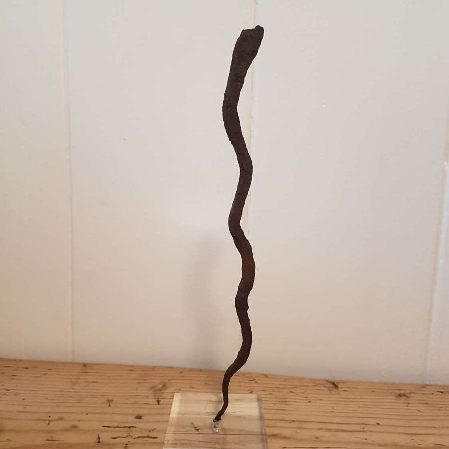 Lobi Iron Snake Currency on lucite stand. Smaller one