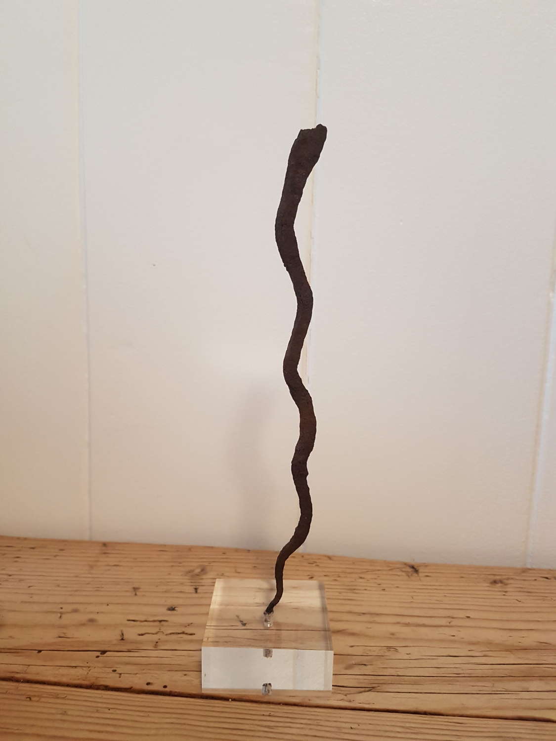 Lobi Iron Snake Currency on lucite stand. Smaller one